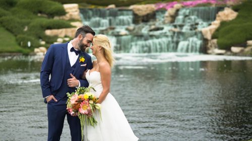 Bride and groom in front of waterfal