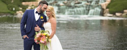 Bride and groom in front of waterfall