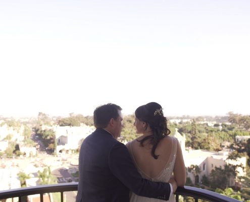 bride and groom at the top of the tower of the Museum of Man in Balboa Park looking out over San Diego