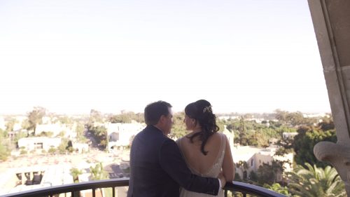 bride and groom at the top of the tower of the Museum of Man in Balboa Park looking out over San Diego