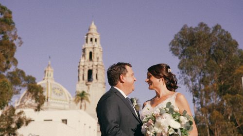 bride and groom with he tower of the Museum of Man in Balboa Park in the background