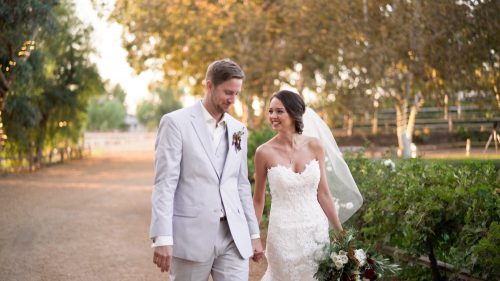 Bride and groom walking at Lake Oak Meadows in Temecula.