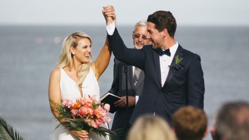 Bride and groom go down the aisle wedding surfrider beach