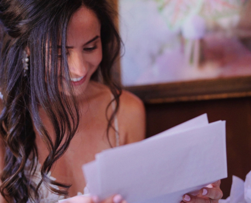 Mt. Woodson Castle Wedding Bride reads groom's letter before ceremony