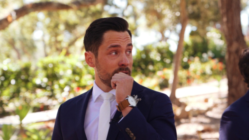 Emotional groom at wedding before bride comes down the aisle