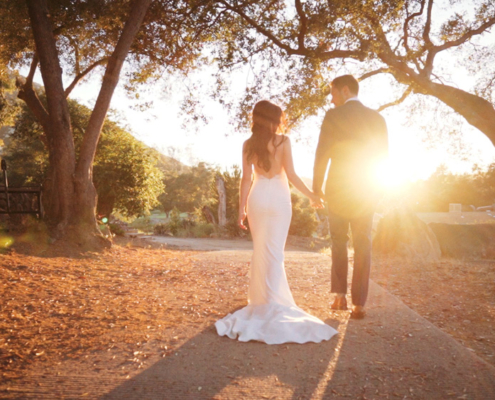 Mt. Woodson Castle Wedding Bride and Groom walking in sunlight