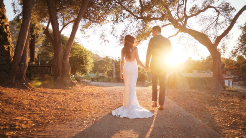 Mt. Woodson Castle Wedding Bride and Groom walking in sunlight