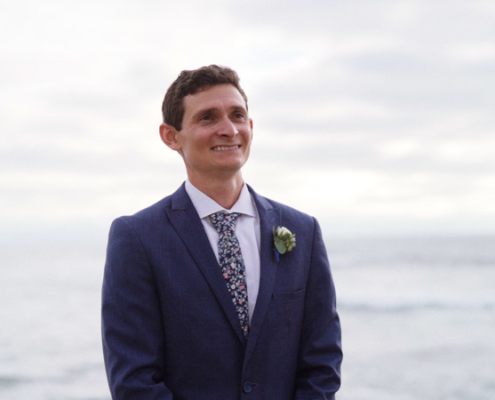 Groom stands in front of ocean La Jolla Cove Wedding Video