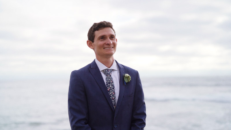 Groom stands in front of ocean La Jolla Cove Wedding Video