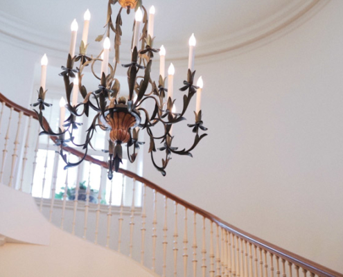 Stairs with chandelier at Darlington House in La Jolla