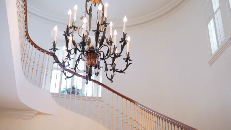 Stairs with chandelier at Darlington House in La Jolla