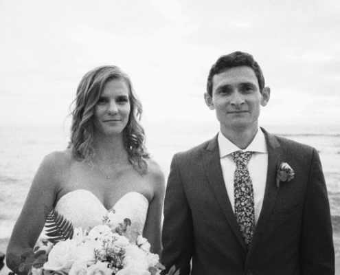 Bride and groom stand together at La Jolla Cove Wedding Video