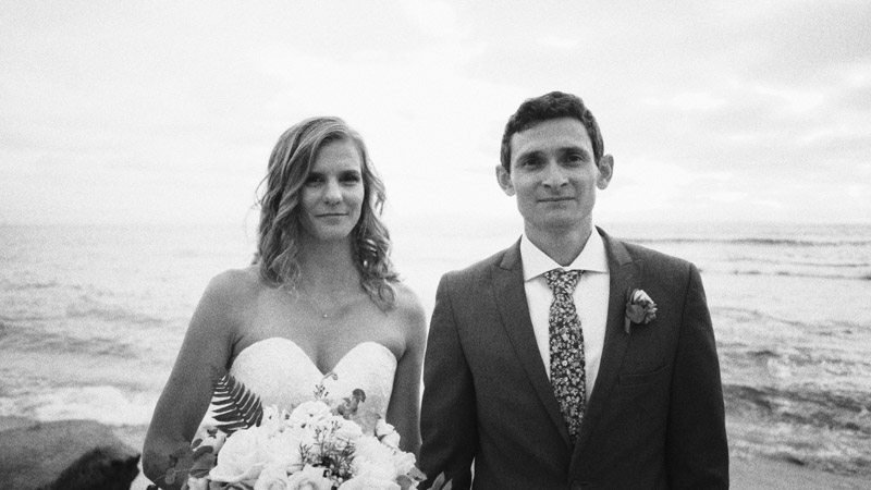 Bride and groom stand together at La Jolla Cove Wedding Video