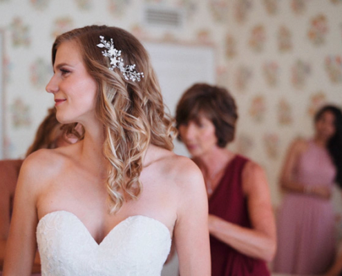 Lacing up wedding dress before the ceremony