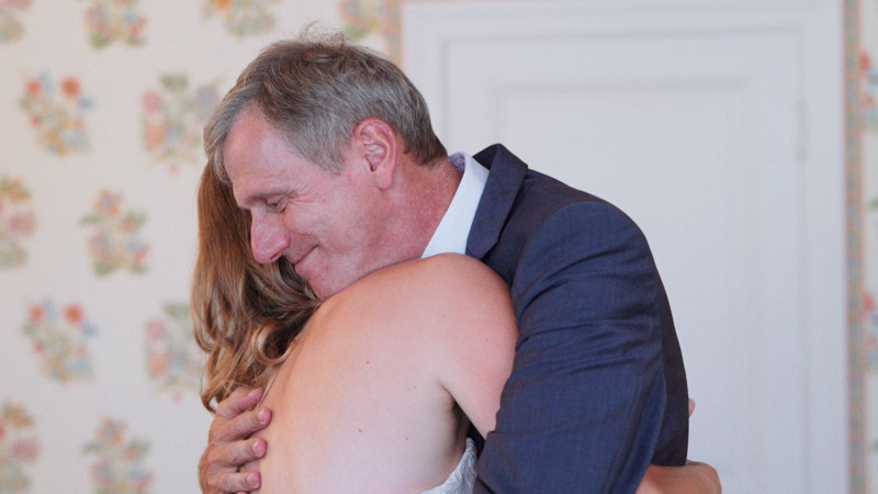 Happy father of the bride hugs his daughter