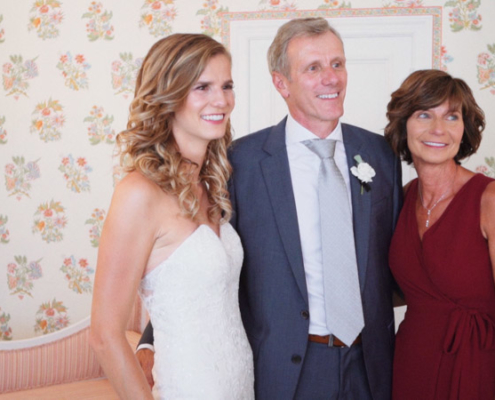 Bride poses with parents at Darlington House in La Jolla