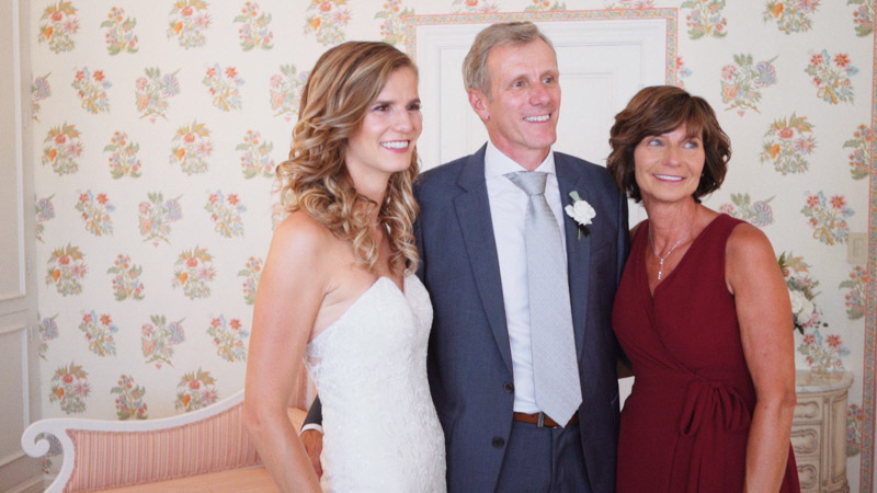 Bride poses with parents at Darlington House in La Jolla