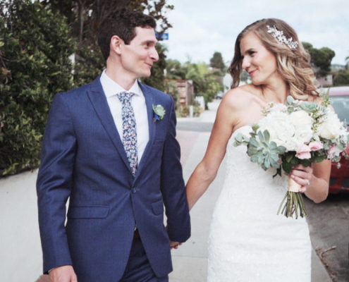 Bride and groom walk on street in La Jolla