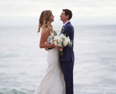 Bride and groom stand in front of ocean La Jolla Cove Wedding Video