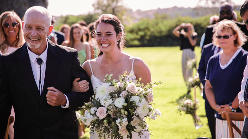 Bride walks down the aisle with father at Ethereal Gardens