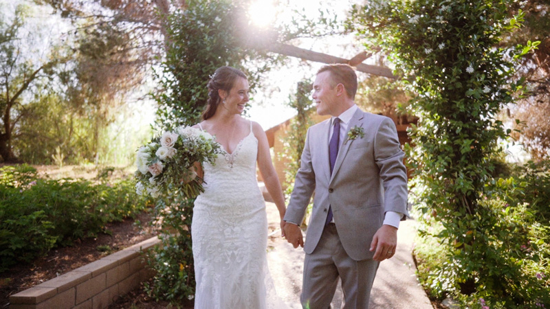Bride and groom walk together at Ethereal Gardens
