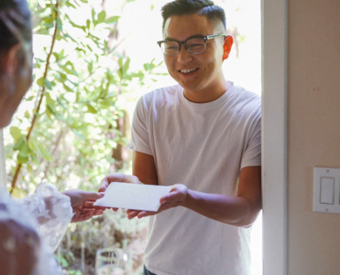 Grooms friend brings card to bride