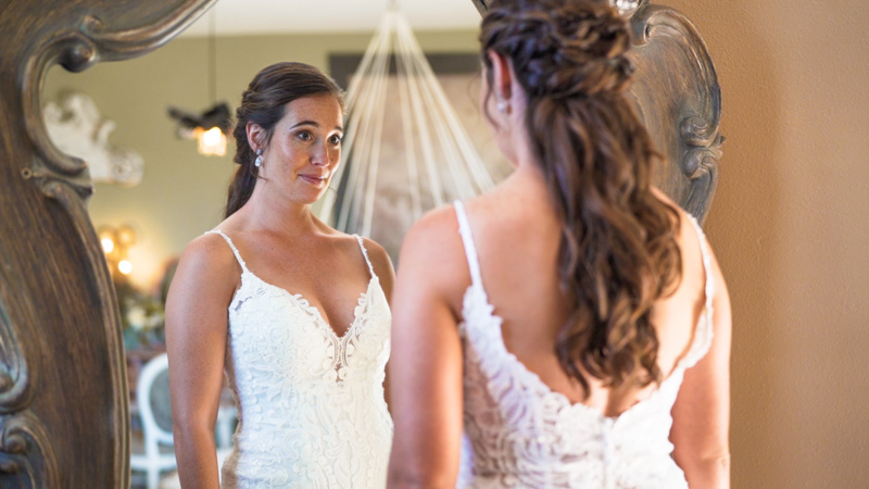 bride looks in the mirror