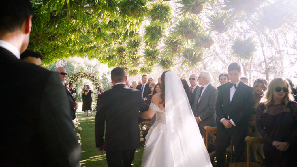 Ethereal Gardens Wedding Bride walks down the aisle with Dad
