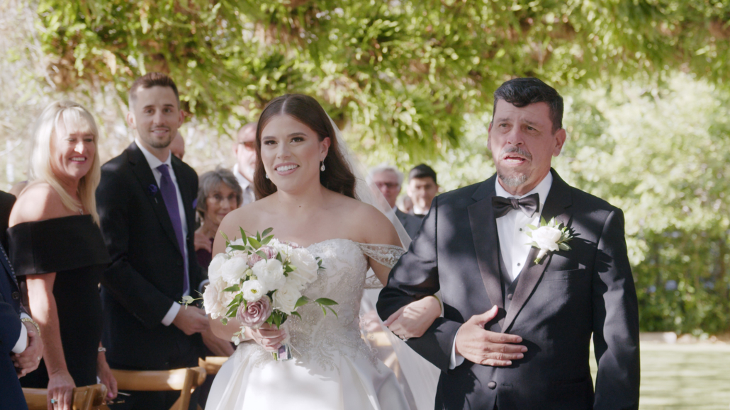 Ethereal Gardens Wedding Bride walks down the aisle with dad