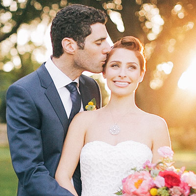 bride and groom in front of sunset