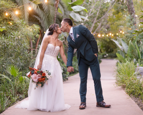 Bride and groom taking wedding photos at Botanica