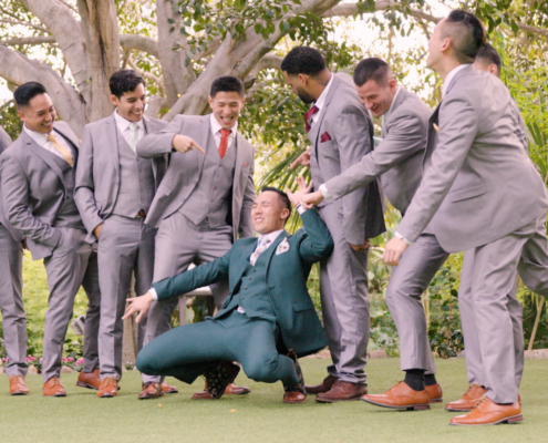 Groom and groomsmen having fun at wedding at Botanica