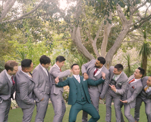 Groom having fun with Groomsmen at wedding at Botanica