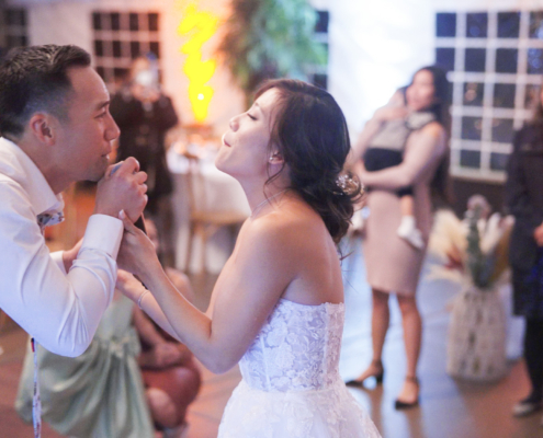 Bride and groom singing to eachother at reception